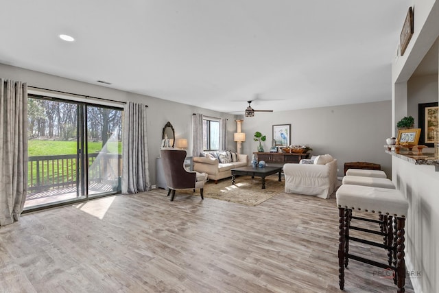 living area featuring a ceiling fan, recessed lighting, and light wood-style floors
