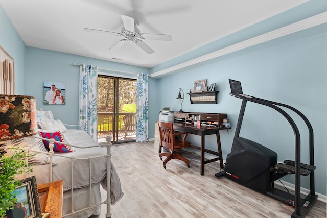 bedroom with ceiling fan, access to outside, wood finished floors, and visible vents