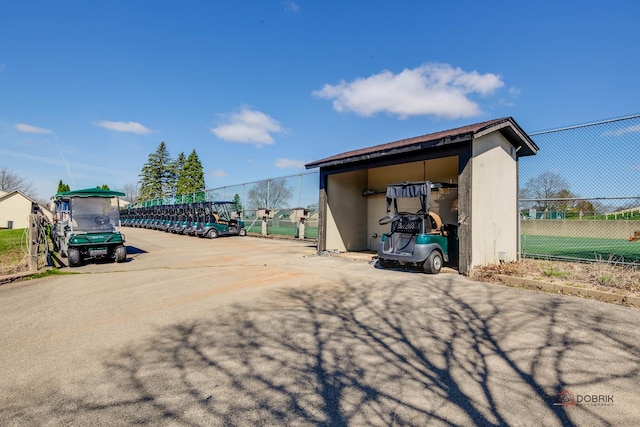 view of parking / parking lot featuring fence