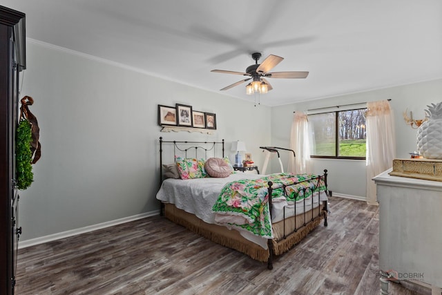 bedroom featuring wood finished floors, crown molding, baseboards, and ceiling fan