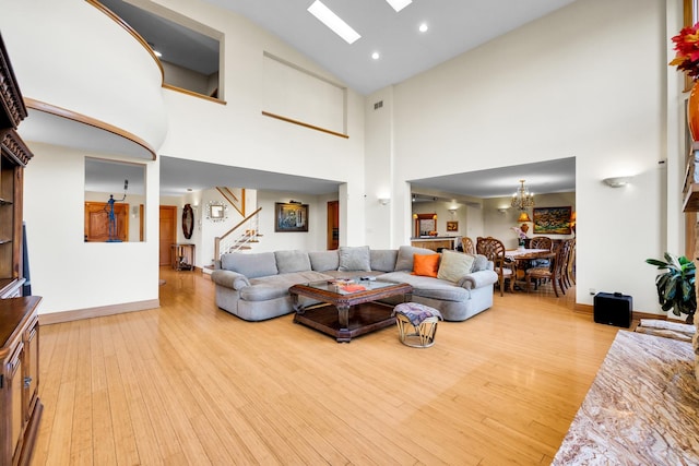 8209 N Oleander Ave, Niles, IL 60714 - living room featuring high vaulted ceiling, stairs, wood finished floors, a skylight, and recessed lighting