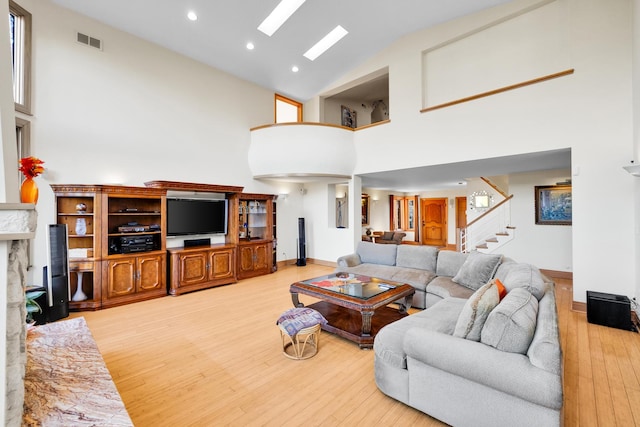 8209 N Oleander Ave, Niles, IL 60714 - living area with high vaulted ceiling, light wood finished floors, stairs, and recessed lighting