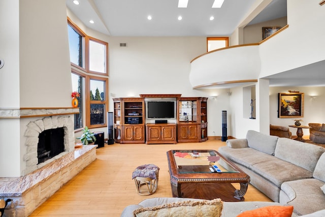 8209 N Oleander Ave, Niles, IL 60714 - living area featuring a high ceiling, hardwood / wood-style floors, recessed lighting, a fireplace, and a skylight