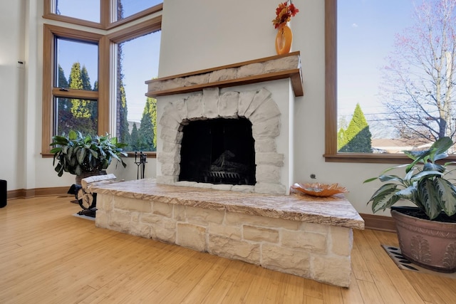 8209 N Oleander Ave, Niles, IL 60714 - living room featuring wood finished floors, plenty of natural light, and a stone fireplace