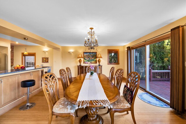 8209 N Oleander Ave, Niles, IL 60714 - dining area with light wood-style flooring and a chandelier