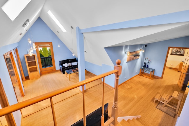 8209 N Oleander Ave, Niles, IL 60714 - stairway featuring a skylight, wood finished floors, and lofted ceiling