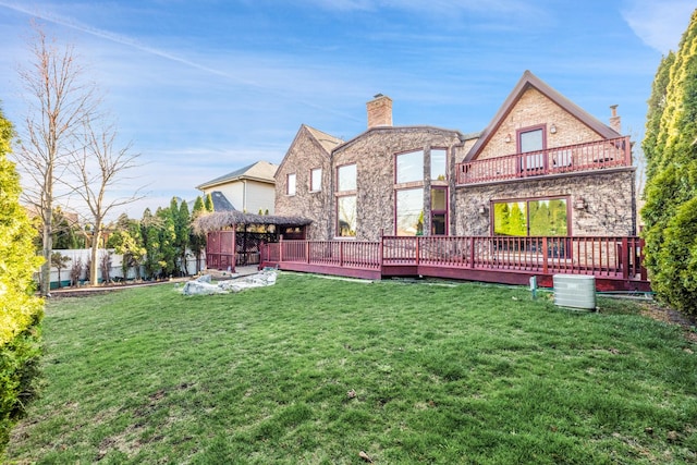 8209 N Oleander Ave, Niles, IL 60714 - rear view of house featuring a chimney, a balcony, a wooden deck, stone siding, and a lawn