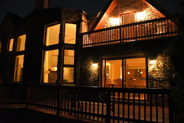 8209 N Oleander Ave, Niles, IL 60714 - back of house at night featuring stone siding and a balcony
