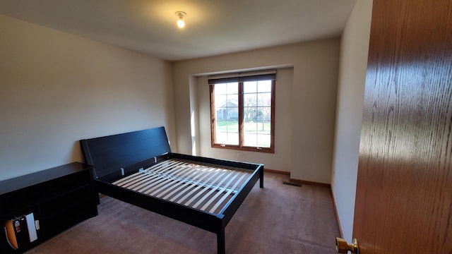 bedroom featuring baseboards, visible vents, and carpet flooring