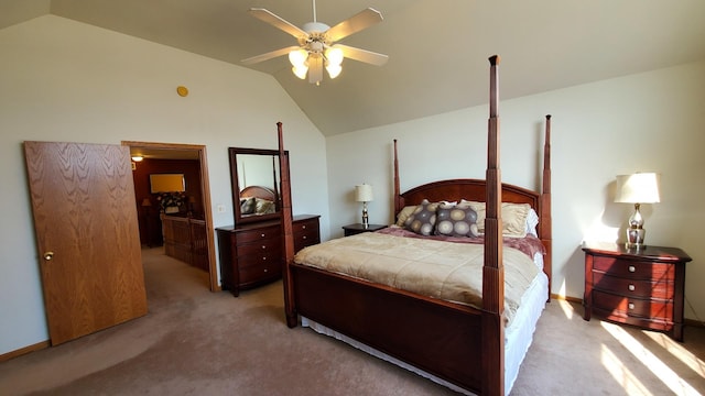 bedroom featuring ceiling fan, vaulted ceiling, and light carpet
