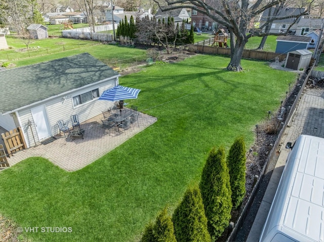 137 S Hickory St, Palatine, IL 60067 - view of yard featuring a fenced backyard, an outdoor structure, a patio, and a storage shed