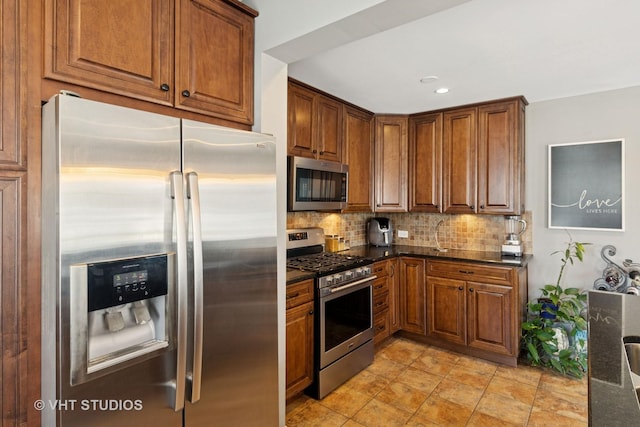 137 S Hickory St, Palatine, IL 60067 - kitchen with brown cabinetry, appliances with stainless steel finishes, dark stone counters, and decorative backsplash