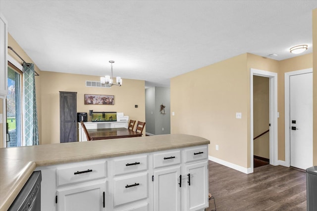 kitchen with an inviting chandelier, white cabinets, dark wood-type flooring, visible vents, and stainless steel dishwasher
