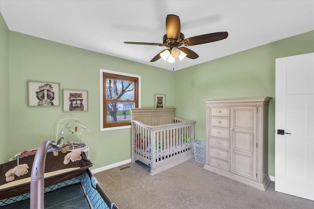 carpeted bedroom featuring visible vents, baseboards, and a ceiling fan