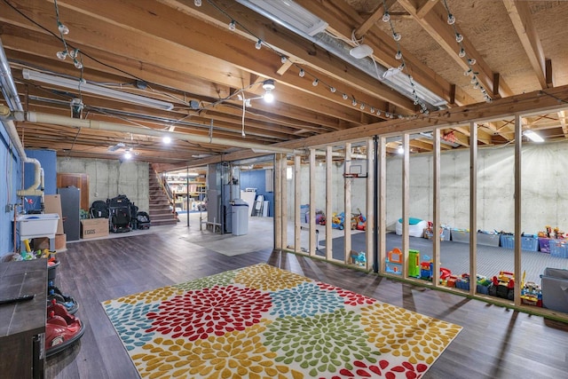 unfinished below grade area featuring wood finished floors and stairs