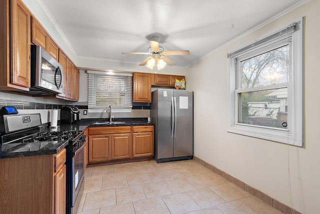 303 Sauk Trl, Park Forest, IL 60466 - kitchen featuring appliances with stainless steel finishes, a sink, brown cabinetry, plenty of natural light, and ornamental molding