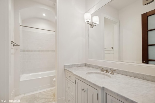 full bathroom featuring toilet, vanity, tile patterned flooring, and  shower combination