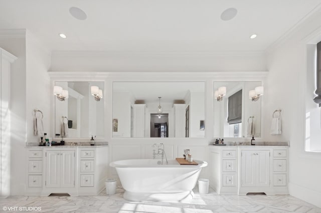 bathroom featuring crown molding, two vanities, a freestanding bath, and marble finish floor