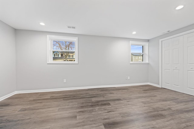 unfurnished bedroom featuring recessed lighting, baseboards, and wood finished floors
