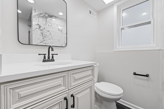 bathroom featuring vanity, visible vents, recessed lighting, toilet, and baseboards