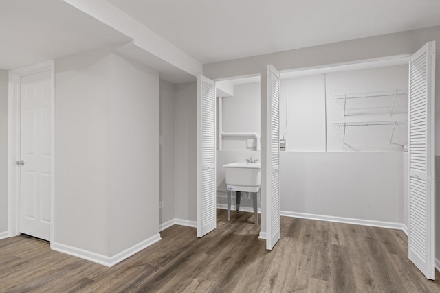 unfurnished bedroom featuring wood finished floors and baseboards