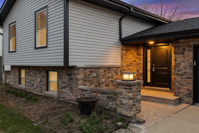 view of property exterior with stone siding