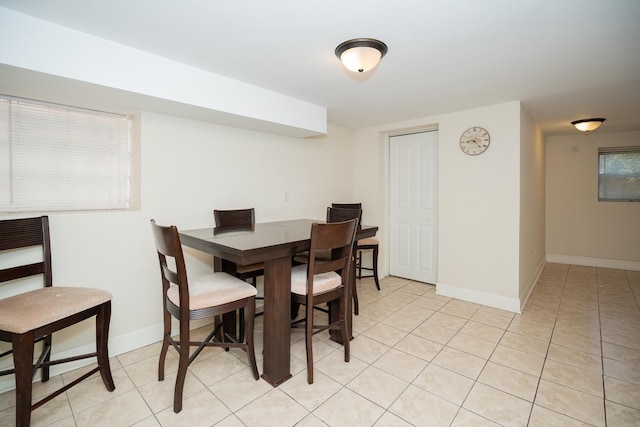 dining room featuring light tile patterned floors and baseboards