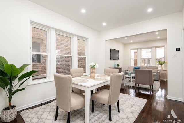 dining space with baseboards, dark wood finished floors, and recessed lighting