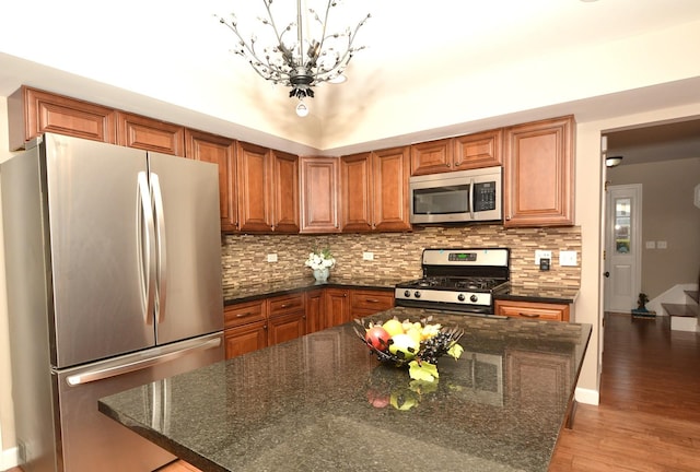 241 Butte View Dr N, Bolingbrook, IL 60490 - kitchen with a chandelier, brown cabinets, decorative backsplash, stainless steel appliances, and light wood finished floors