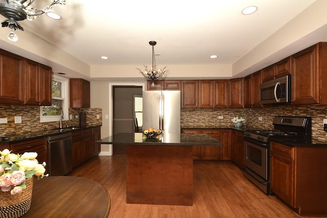 241 Butte View Dr N, Bolingbrook, IL 60490 - kitchen with tasteful backsplash, a center island, appliances with stainless steel finishes, a chandelier, and wood finished floors