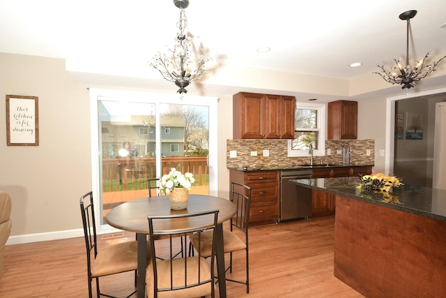 241 Butte View Dr N, Bolingbrook, IL 60490 - kitchen featuring brown cabinets, dishwasher, light wood-type flooring, and an inviting chandelier