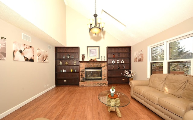 241 Butte View Dr N, Bolingbrook, IL 60490 - living room with a brick fireplace, visible vents, wood finished floors, and lofted ceiling