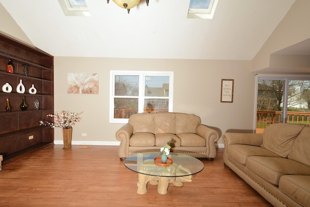 241 Butte View Dr N, Bolingbrook, IL 60490 - living room with vaulted ceiling with skylight, baseboards, and wood finished floors