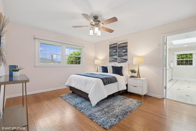1115 S Vail Ave, Arlington Heights, IL 60005 - bedroom with baseboards, wood finished floors, a skylight, and ceiling fan
