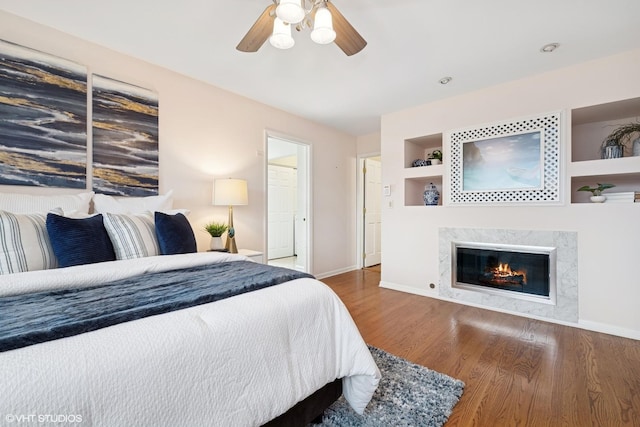 1115 S Vail Ave, Arlington Heights, IL 60005 - bedroom with baseboards, wood finished floors, a premium fireplace, and a ceiling fan