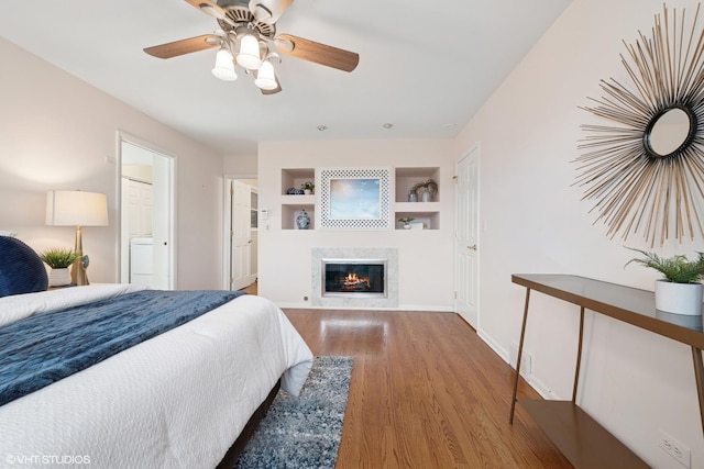 1115 S Vail Ave, Arlington Heights, IL 60005 - bedroom featuring wood finished floors, a glass covered fireplace, ceiling fan, and baseboards