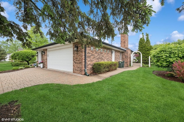1115 S Vail Ave, Arlington Heights, IL 60005 - view of side of property with a lawn, a garage, a chimney, decorative driveway, and brick siding