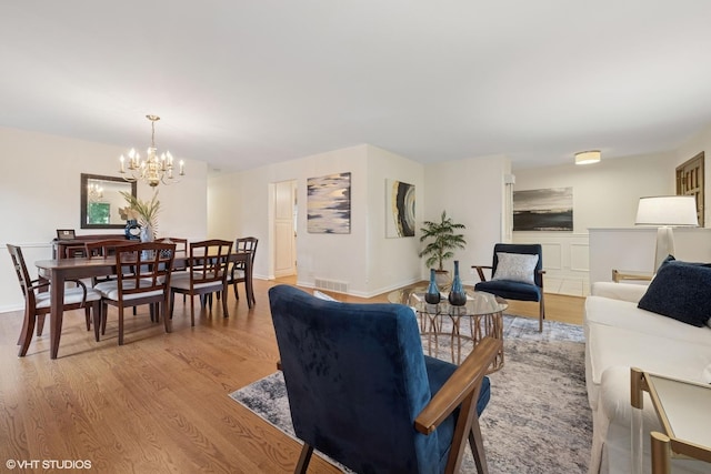 1115 S Vail Ave, Arlington Heights, IL 60005 - living area with a chandelier, light wood finished floors, and baseboards