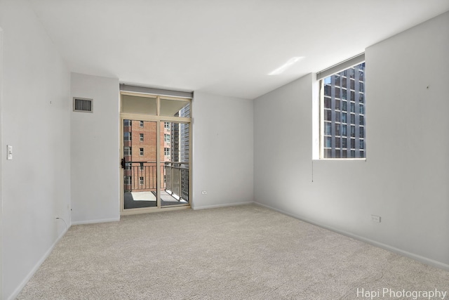 21 W Chestnut St Unit 1509, Chicago, IL 60610 - carpeted spare room with floor to ceiling windows and baseboards