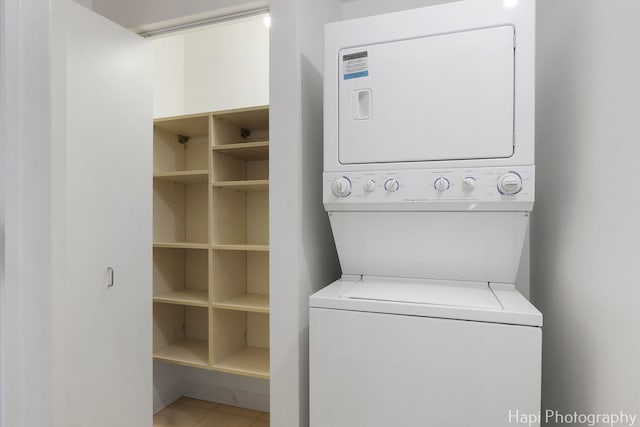 21 W Chestnut St Unit 1509, Chicago, IL 60610 - washroom with stacked washer and clothes dryer and tile patterned floors