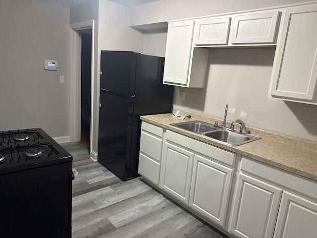 506 S Edison Ave, Elgin, IL 60123 - kitchen with black appliances, light wood-style flooring, white cabinets, and light countertops