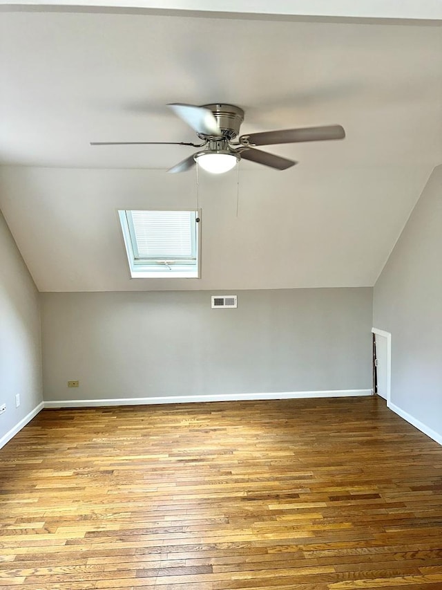 506 S Edison Ave, Elgin, IL 60123 - additional living space with a skylight, vaulted ceiling, wood finished floors, and a ceiling fan