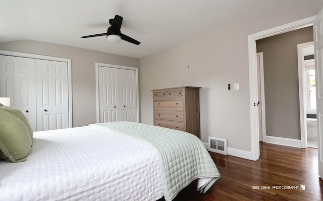 bedroom featuring multiple closets, a ceiling fan, baseboards, wood finished floors, and visible vents