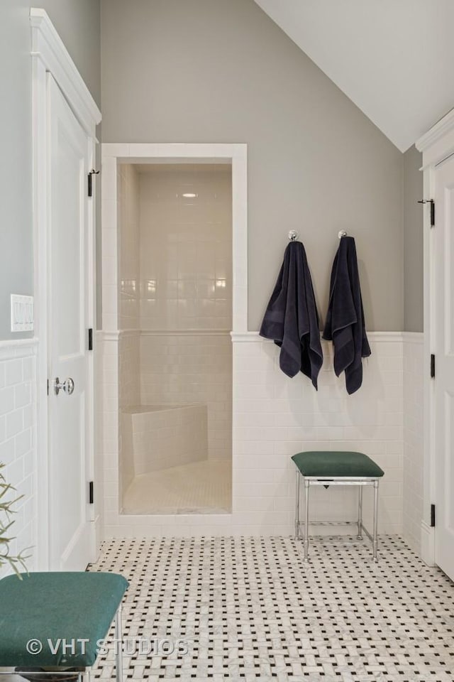 1605 N Chicago Ave, Arlington Heights, IL 60004 - full bath featuring lofted ceiling, wainscoting, a walk in shower, tile patterned flooring, and tile walls