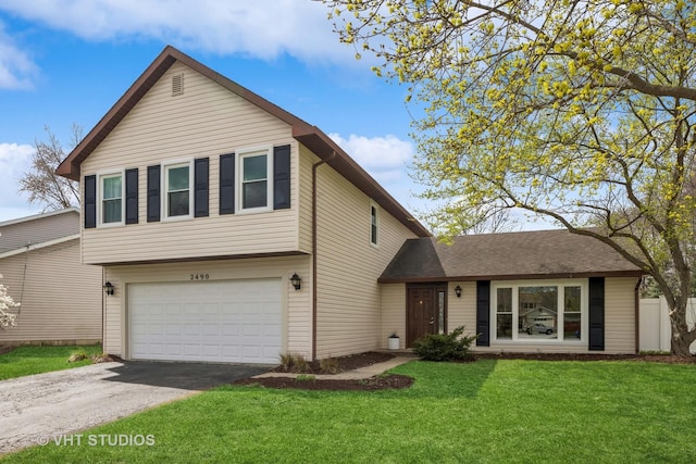 tri-level home with a garage, driveway, and a front lawn