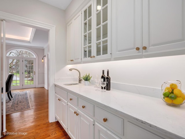 8 Longwood Dr, Burr Ridge, IL 60527 - bar featuring light wood-type flooring, ornamental molding, a sink, french doors, and baseboards