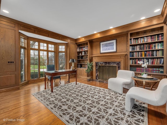 8 Longwood Dr, Burr Ridge, IL 60527 - home office with a premium fireplace, light wood-style floors, wood walls, and built in shelves