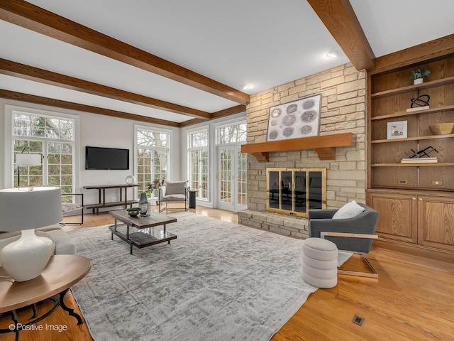 8 Longwood Dr, Burr Ridge, IL 60527 - living room featuring beam ceiling, a stone fireplace, and light wood finished floors