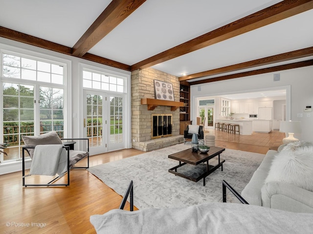 8 Longwood Dr, Burr Ridge, IL 60527 - living area with light wood-style floors, beamed ceiling, and a stone fireplace