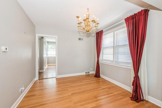 1919 Sunnyside Ave, Westchester, IL 60154 - spare room with a chandelier, light wood finished floors, and baseboards
